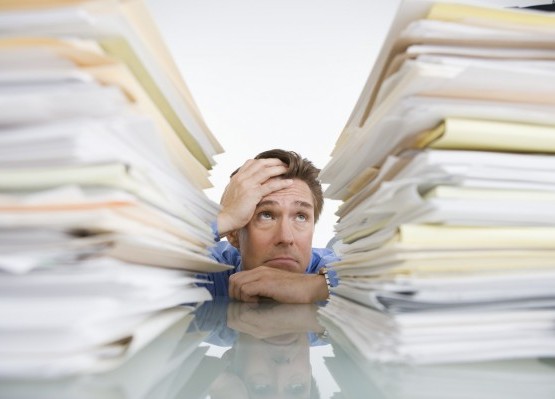 Businessman Overwhelmed with Paperwork