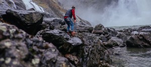 hiker following a difficult trail through large rocks